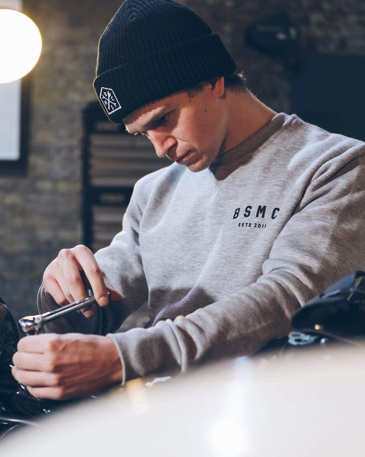 Harry working on his bike wearing our BSMC ESTD. Sweatshirt - Grey Marl